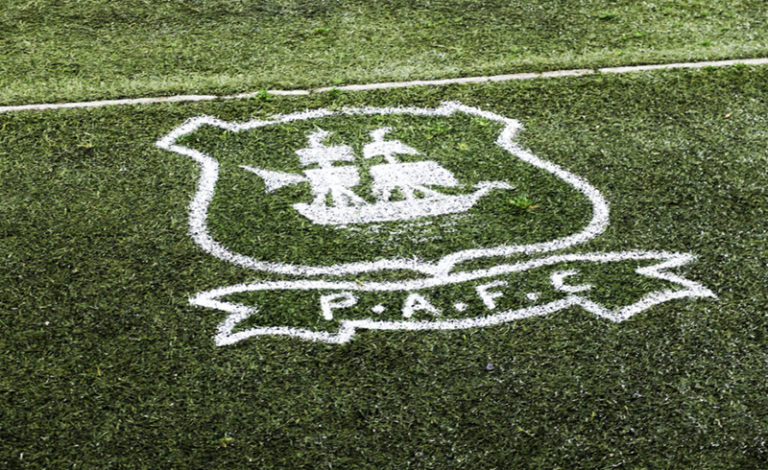 The Plymouth Argyle F.C. badge, featuring the Mayflower emblem, at Home Park stadium.